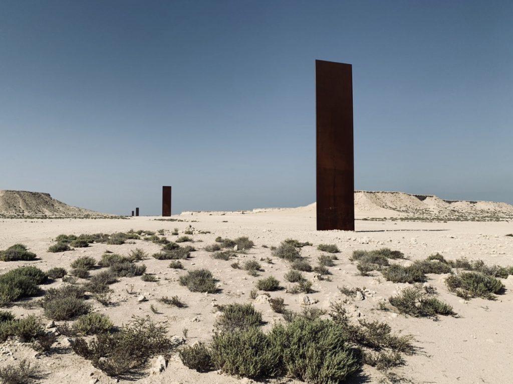 Four large amber colored vertical steel Sculptures by Richard Serra  in the desert of Qatar