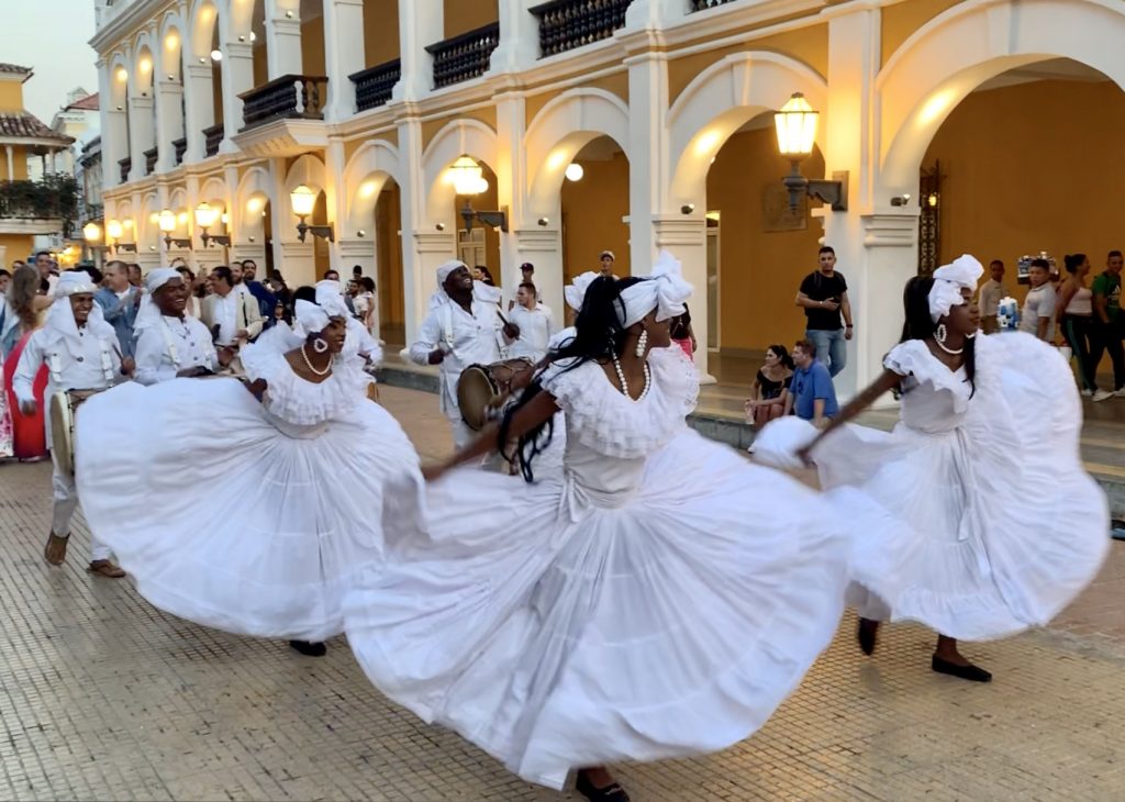 Wedding procession in Colombia with dancers in white dresses