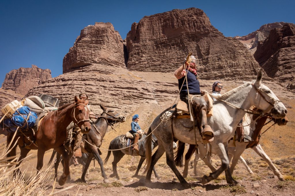 Crossing the Piuquenes Pass trail on horseback.