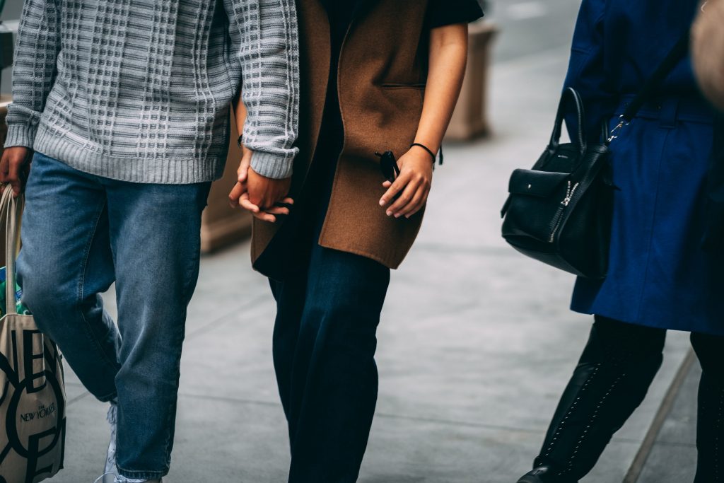 Couple holding hands in New York before the pandemic. Photo by Petar Pavlov