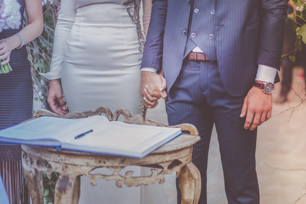 Couple holding hands during a wedding ceremony