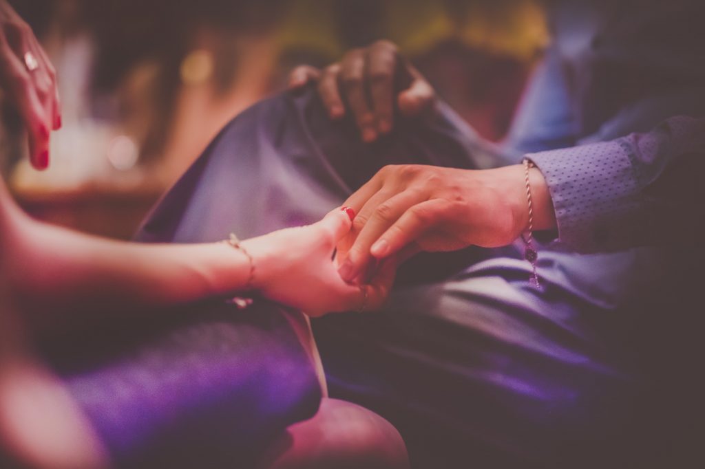 Gently holding hands during a conversation. Photo by Petar Pavlov