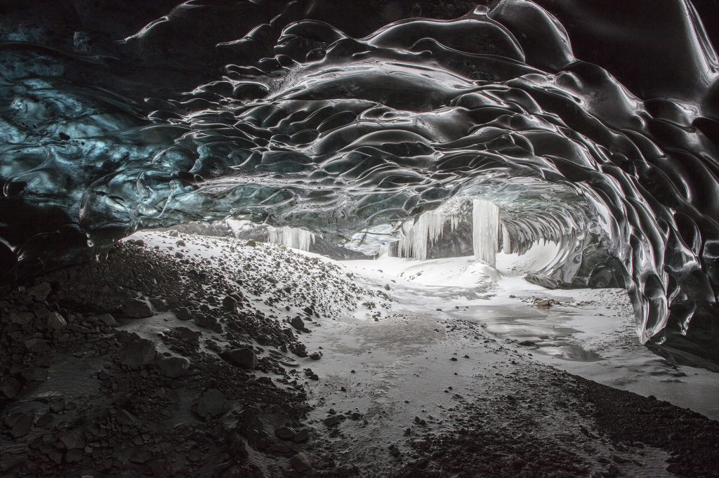 The narrow entrance of the black ice caves in Iceland