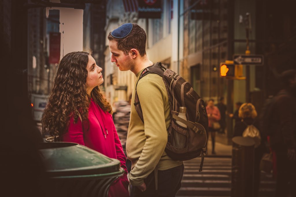 A couple gazing at each other in a buys street, Photo by Petar Pavlov. 