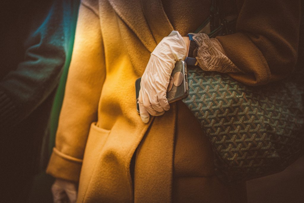 A hand wearing a glove during the pandemic - Photo by Petar Pavlov. 