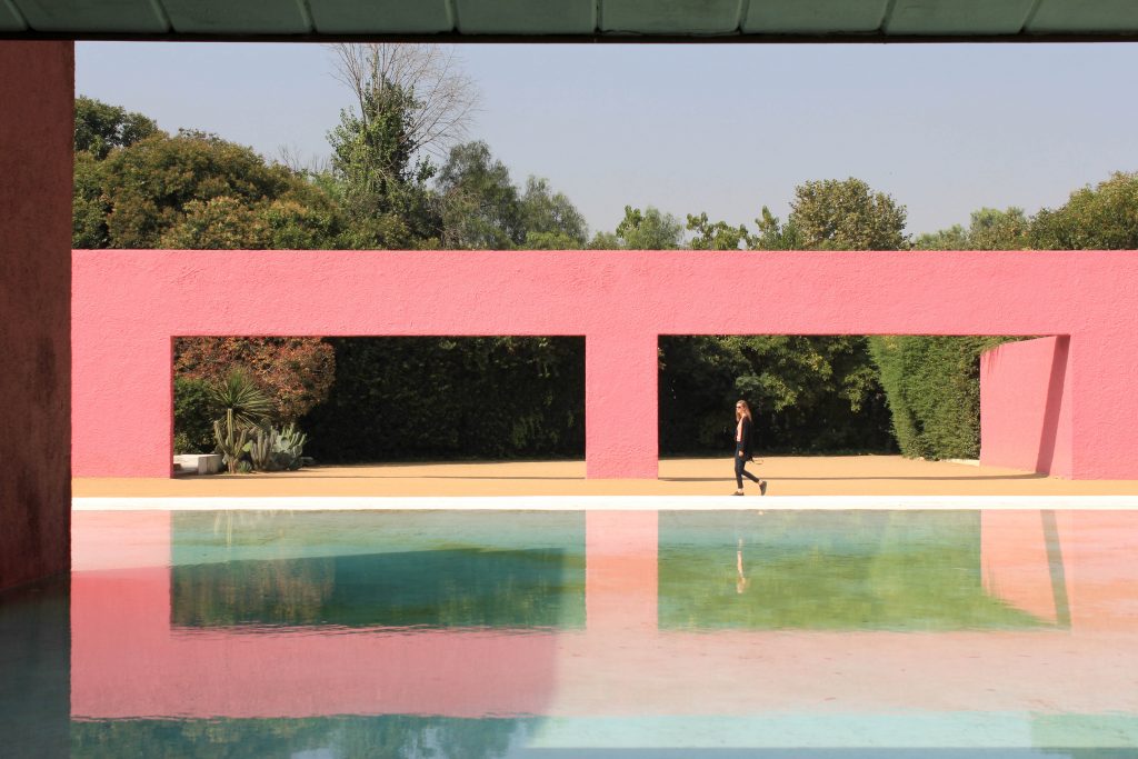 Barragán's geometric architecture reflected in a pool.