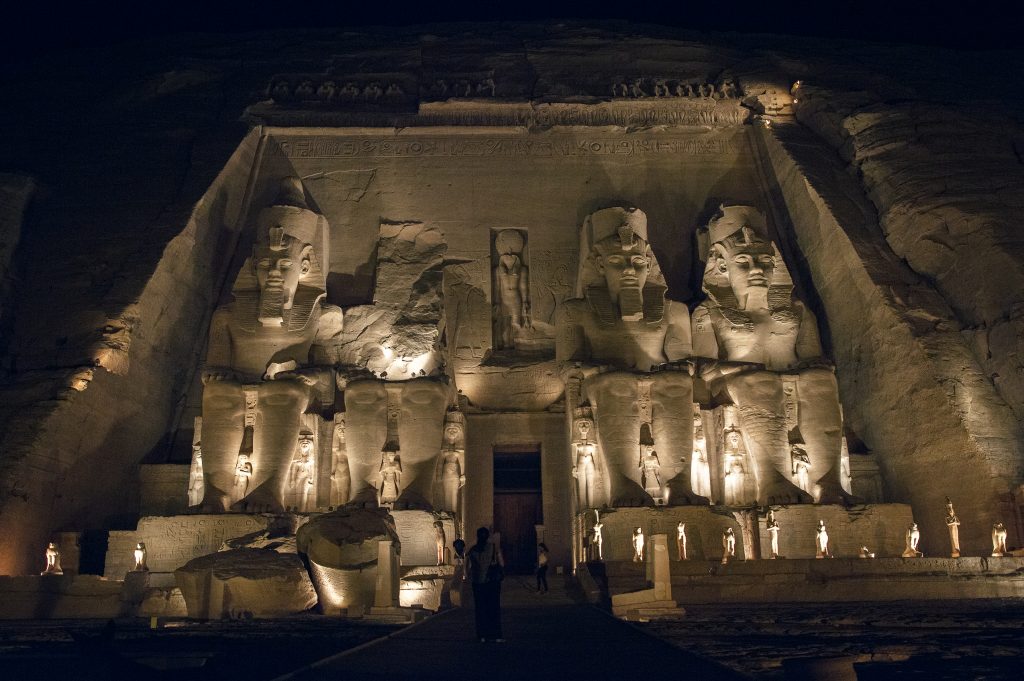 Abu Simbel Egypt at night with lights dancing against the structure.