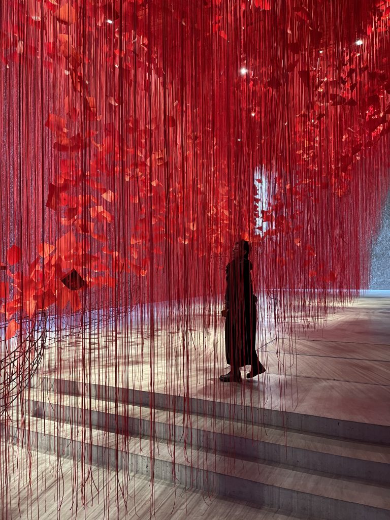 Joanna walking through the "I Hope" Chiharu Shiota Exhibition in Berlin.