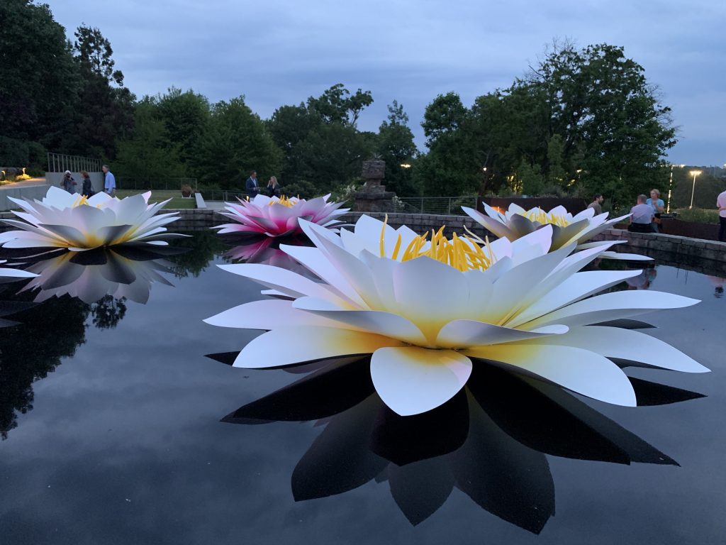 Massive water lily sculptures rest on the water at Atlanta Botanical Garden