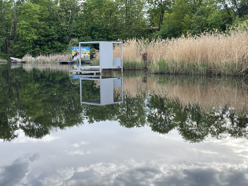 The sky reflects off the water at the Floating University of Berlin